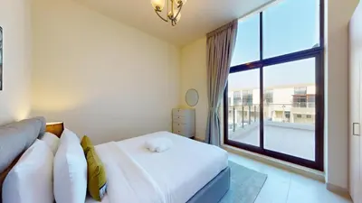 a bedroom with a bed and a large window at Locations l Spectacular 4 Bed Villa l Garden l Wadi Al Safa in Dubai