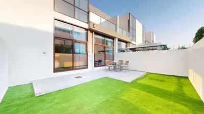 a large white house with a green lawn at Locations l Spectacular 4 Bed Villa l Garden l Wadi Al Safa in Dubai