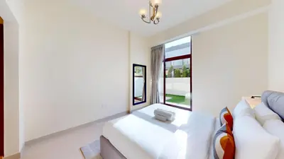 a living room with a white couch and a window at Locations l Spectacular 4 Bed Villa l Garden l Wadi Al Safa in Dubai