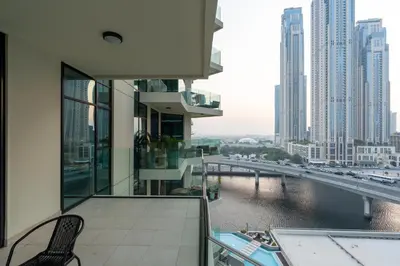 a balcony with a view of a river and buildings at Vacay Lettings - Missoni Luxury 2 BR Urban Oasis Dubai Canal View in Dubai
