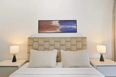a bedroom with a bed with two lamps on tables at Luxury 1BD in Elite Residence, Dubai Marina in Dubai