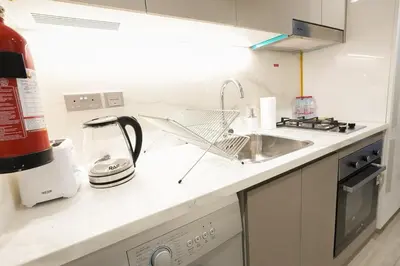a kitchen with a sink and a counter top at Stunning - Cozy Studio - Azizi Riviera in Dubai