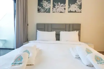 a bedroom with two beds with white sheets and pillows at Stunning - Cozy Studio - Azizi Riviera in Dubai