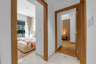 a bedroom with a bed and a living room at Charming 2BR Getaway at Azizi Riviera, MBR City in Dubai