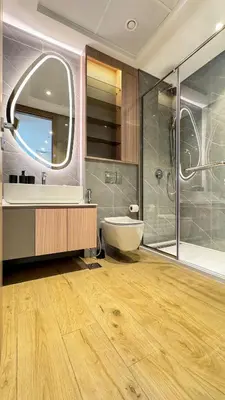a bathroom with a tub and a sink and a mirror at 1BDR near Circle Mall with Sauna, Jaccuzzi and Gym in Dubai