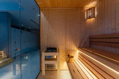 a sauna with a bench in a wooden wall at 1BDR near Circle Mall with Sauna, Jaccuzzi and Gym in Dubai