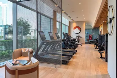 a gym with chairs and treadmills in a building at PVH - Burj Khalifa View 2BR - Vida Dubai Mall in Dubai