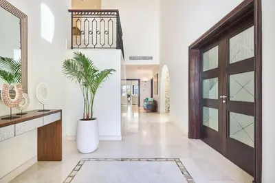 a hallway with a door and a potted plant at JuliusHomes-Villa Noor in Dubai