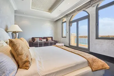 a bedroom with a large bed and a window at JuliusHomes-Villa Noor in Dubai