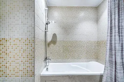 a bathroom with a bath tub with a shower curtain at Elegant 1BR with Balcony in Dubai Marina by EE Holiday Homes in Dubai