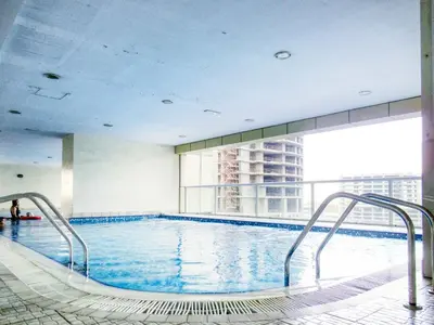 a swimming pool in a building with a large window at Elegant 1BR with Balcony in Dubai Marina by EE Holiday Homes in Dubai