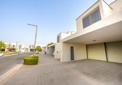 a white building with a sidewalk next to a street at Luxury Maple 3 Villa in Dubai Hills with Private Garden in Dubai