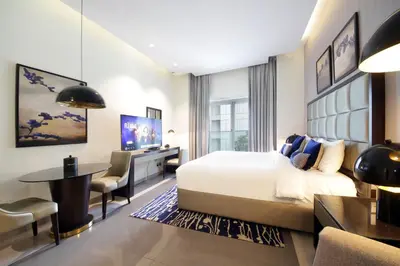 a hotel room with a bed and a desk at Silk Valley - Luxury DAMAC Studio near Dubai Mall & Burj Khalifa in Dubai