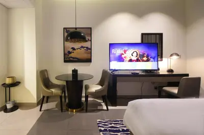 a bedroom with a desk with a computer and chairs at Silk Valley - Luxury DAMAC Studio near Dubai Mall & Burj Khalifa in Dubai