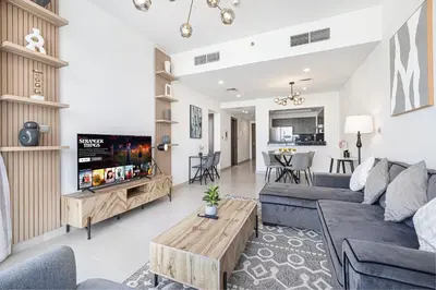 a living room with a couch and a table at Deluxe Nine Tower Suites By Hostiva - Downtown in Dubai