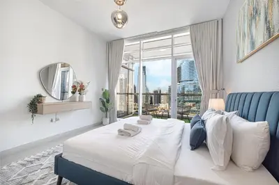 a bedroom with a bed and a large window at Deluxe Nine Tower Suites By Hostiva - Downtown in Dubai