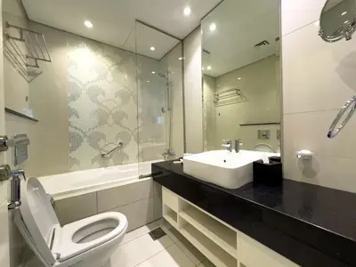a bathroom with a toilet and a sink and a mirror at Werova - Spacious 3-Bedroom Near Dubai Mall in Dubai