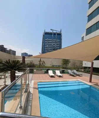 a swimming pool on the roof of a building at Werova - Spacious 3-Bedroom Near Dubai Mall in Dubai