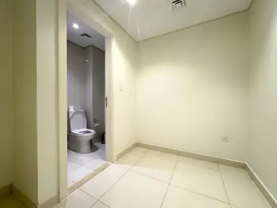 an empty bathroom with a toilet in a room at Werova - Spacious 3-Bedroom Near Dubai Mall in Dubai