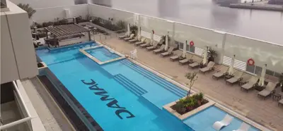 an overhead view of a hotel swimming pool with chairs at Werova - Spacious 3-Bedroom Near Dubai Mall in Dubai