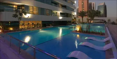 a large swimming pool in the middle of a building at Werova - Spacious 3-Bedroom Near Dubai Mall in Dubai