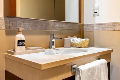 a bathroom counter with a sink and a mirror at Private Room in Luxurious 3BR Apt in Downtown, Direct Access to Dubai Mall and Metro in Dubai
