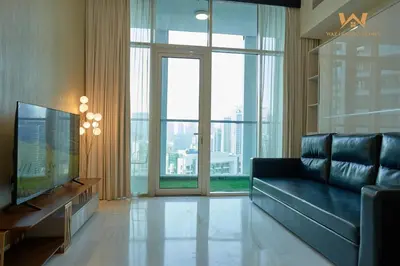 a living room with a couch and a large window at Wake Up to the Burj Khalifa Stunning view 1BR Stay in Dubai