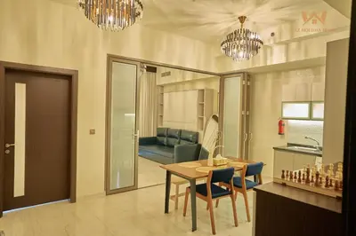 a living room with a table and a couch at Wake Up to the Burj Khalifa Stunning view 1BR Stay in Dubai