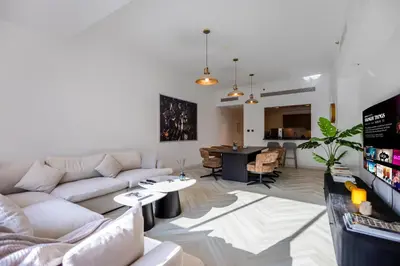 a living room with a couch and a table at Spacious 1BR with Terrace l Near Palm Jumeirah Mall in Dubai