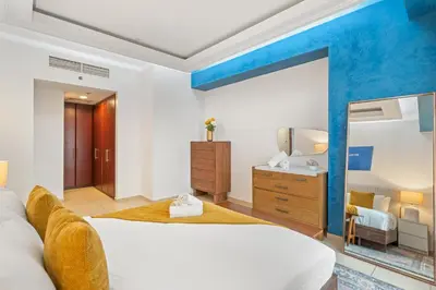 a bedroom with a large bed and a mirror at Luxe 3 Bedroom Apartment with Maid Room, Dubai Eye and Sea View in Dubai