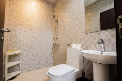 a bathroom with a toilet and a sink at Dezire Premium Fully Furnished 1 BHK Apartment in Dubai