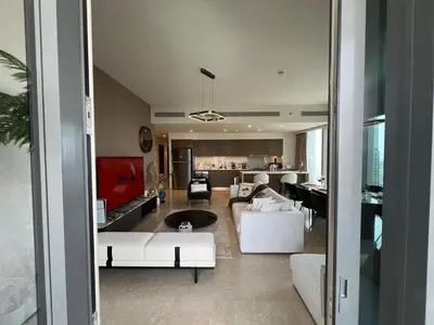 a living room with white furniture and a kitchen at UNIQUE - BURJ KHALIFA & FOUNTAIN ViEW-4 BR in Dubai