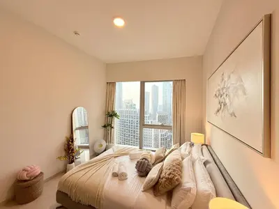 a bedroom with a large bed with a large window at UNIQUE - BURJ KHALIFA & FOUNTAIN ViEW-4 BR in Dubai