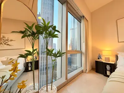 a bedroom with a large window with plants in it at UNIQUE - BURJ KHALIFA & FOUNTAIN ViEW-4 BR in Dubai