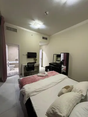 a bedroom with a large bed and a bathroom at Joyful Journeys Marina Arcade Private Room for 2 - Shared Kitchen in Dubai