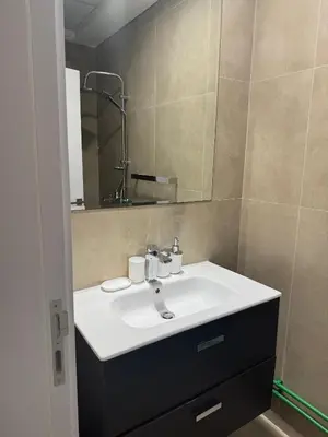 a bathroom with a white sink and a mirror at Joyful Journeys Marina Arcade Private Room for 2 - Shared Kitchen in Dubai