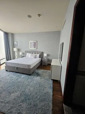 a bedroom with a large bed and a television at Apartment in the heart of Dubai - in Burj Khalifa in Dubai