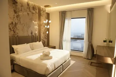 a bedroom with a bed and a large window at The Royale Vista Burj Khalifa View Residence in Dubai