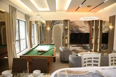a living room with a pool table and a tv at The Royale Vista Burj Khalifa View Residence in Dubai