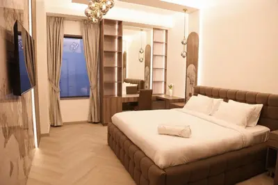 a bedroom with a large bed and a window at The Royale Vista Burj Khalifa View Residence in Dubai
