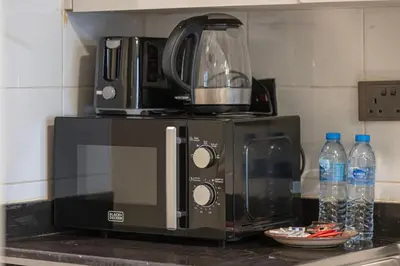 a microwave sitting on top of a kitchen counter at Luxury JLT Studio Lakeview Near Metro & Marina in Dubai