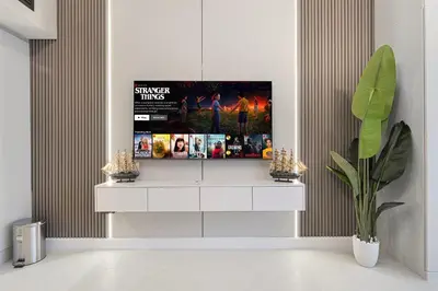 a living room with a tv on a wall at Luxury JLT Studio Lakeview Near Metro & Marina in Dubai