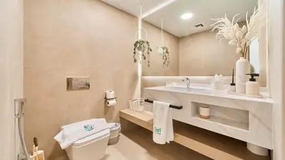 a bathroom with a white toilet and a sink at fam Living High Floor Stay in Sulafa Tower in Dubai