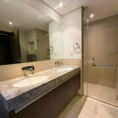 a bathroom with two sinks and a shower at Spacious Luxury Apartment Stunning Creek Views Family Friendly in Dubai