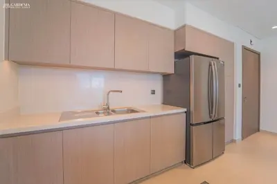 a kitchen with a sink and a refrigerator at Burj Khalifa - Fountain View - Astonishing Home in Dubai