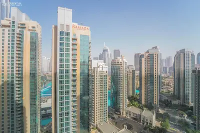 a view of a large city with tall buildings at Burj Khalifa - Fountain View - Astonishing Home in Dubai