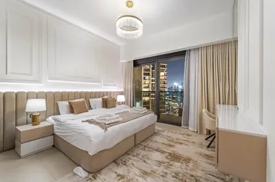 a bedroom with a bed and a desk and a window at Modern stylish 2BR Apartment walk to Dubai Mall near Burj Khalifa in Dubai
