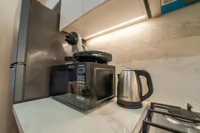 a coffee maker on a counter in a kitchen at EasyGo - Elegant 1-Bedroom Apartment with Balcony in Dubai