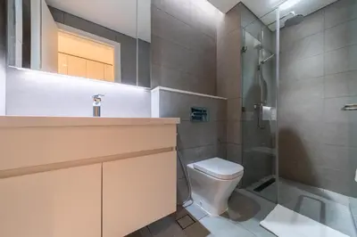 a bathroom with a toilet and a shower at Modern studio - Burj & canal view in Dubai