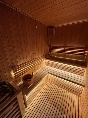 an empty wooden sauna with a bucket in it at Modern studio - Burj & canal view in Dubai